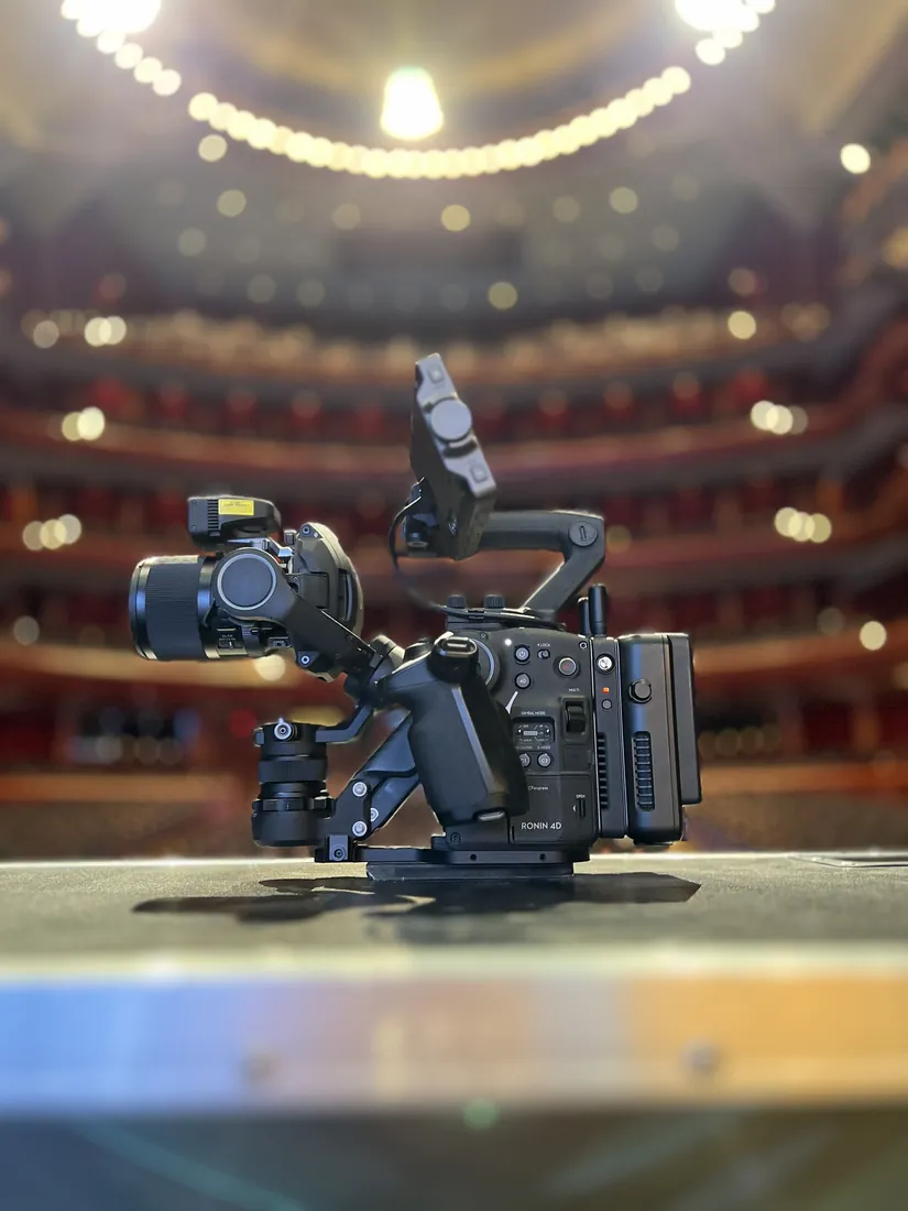 A cinema camera set up in an empty theater.